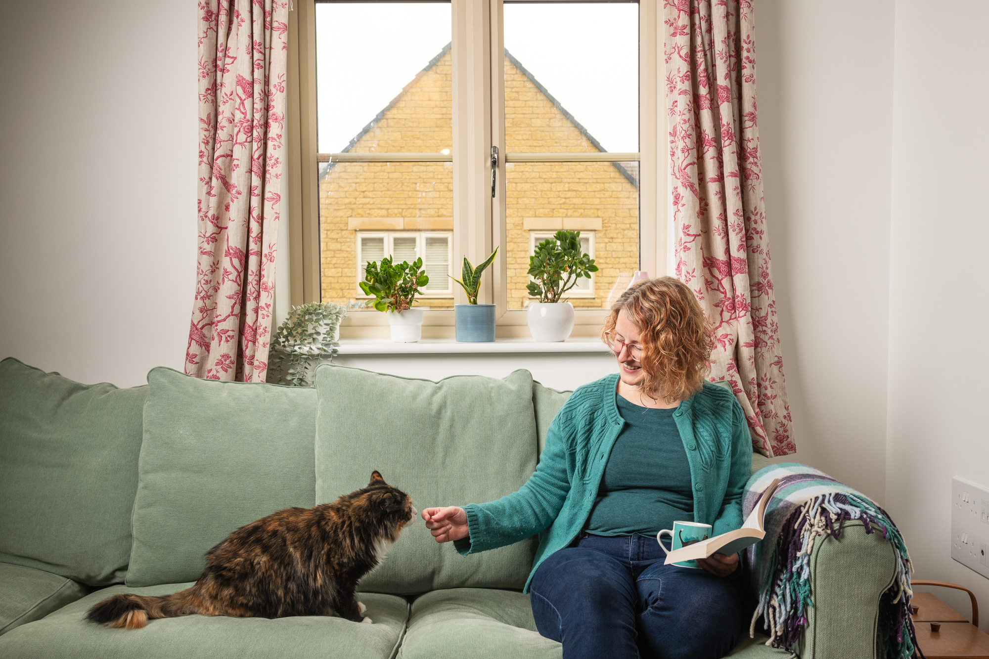 Sparrow customer on sofa with cat