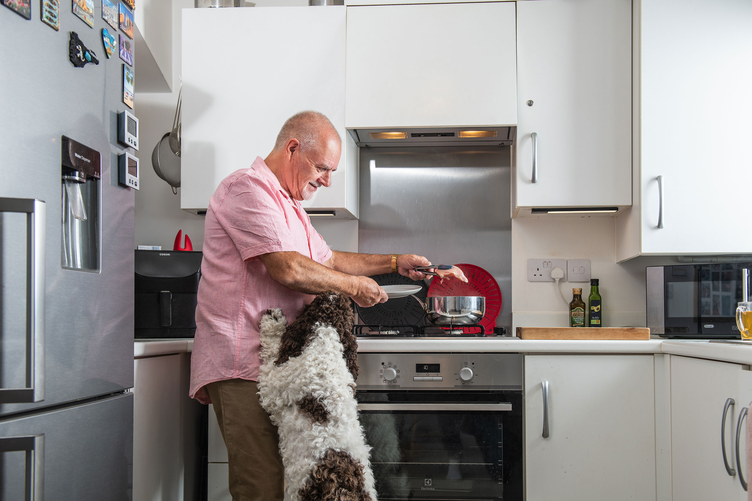 A Sparrow customer cooking in kitchen with dog