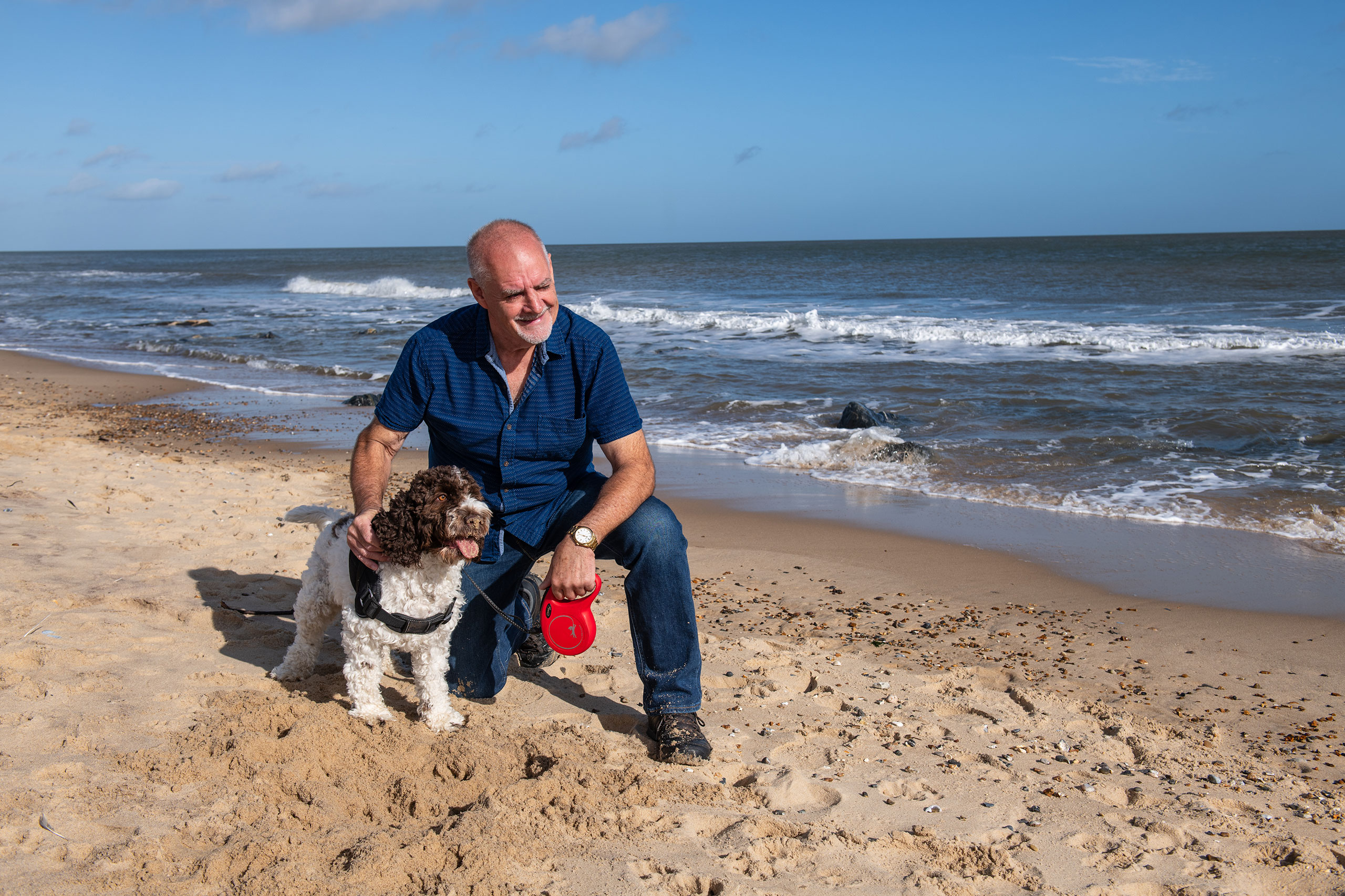 A Sparrow customer on beach with their dog