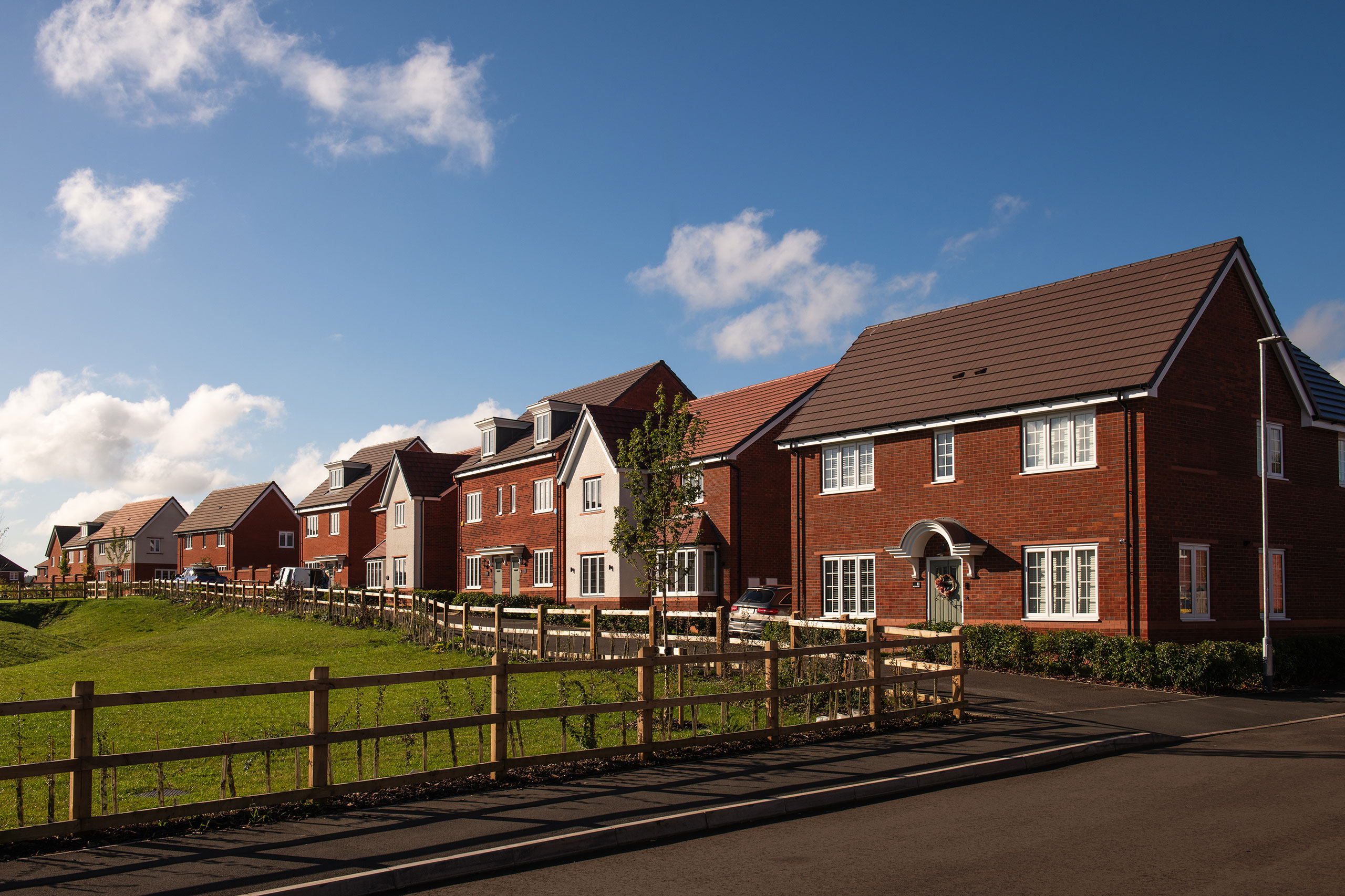 Row of houses behind green field