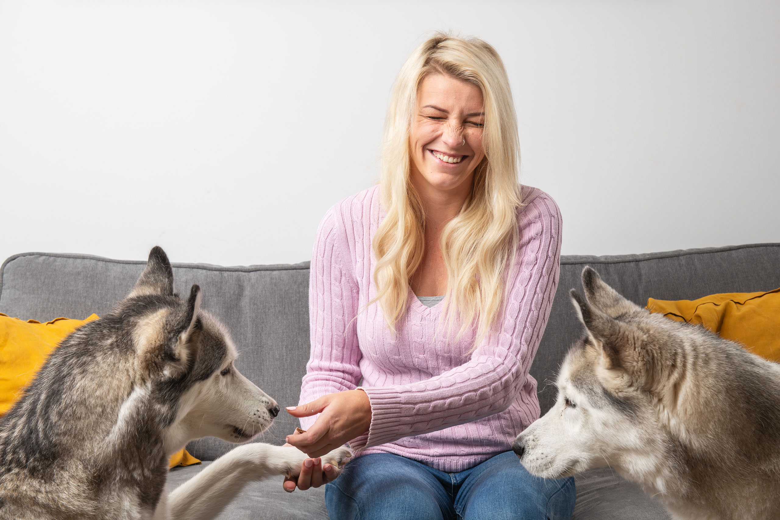 A Sparrow customer laughing with their two dogs